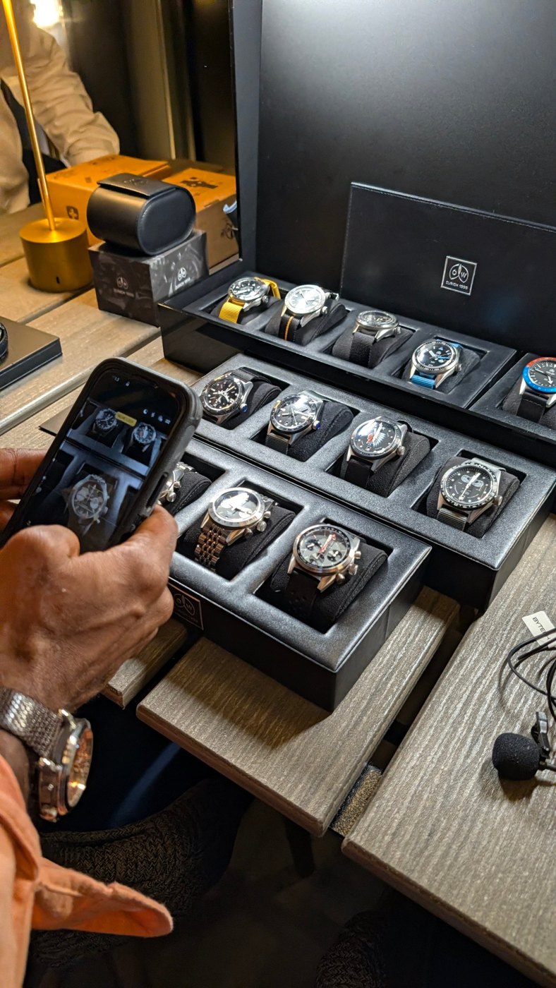 A visitor photographing Ollech & Wajs watches with his phone at The HYPE NYC.